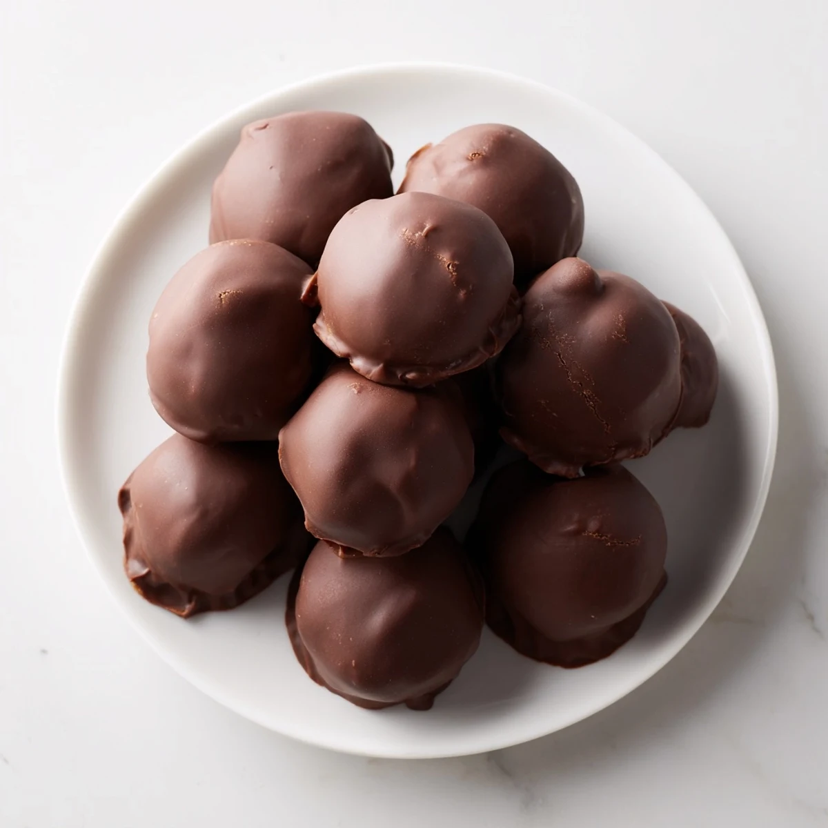 Image of glistening Chocolate Peanut Butter Balls, a decadent no-bake dessert ready to enjoy.