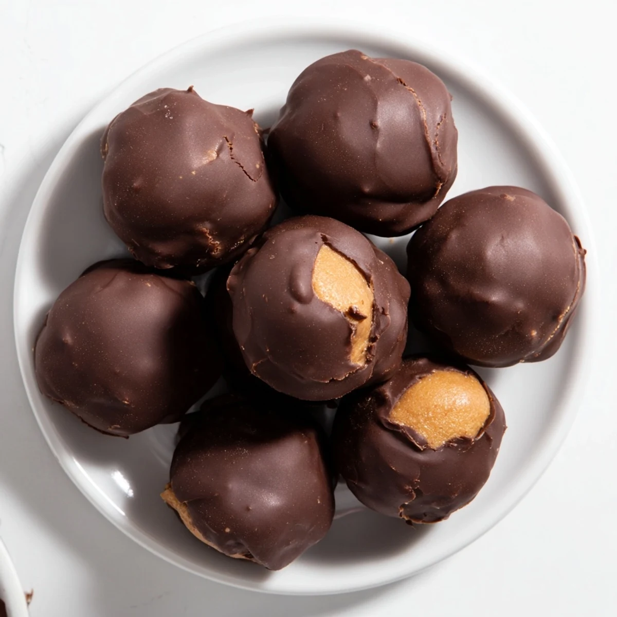 See these homemade Chocolate Peanut Butter Balls, perfectly round and coated in smooth, dark chocolate.