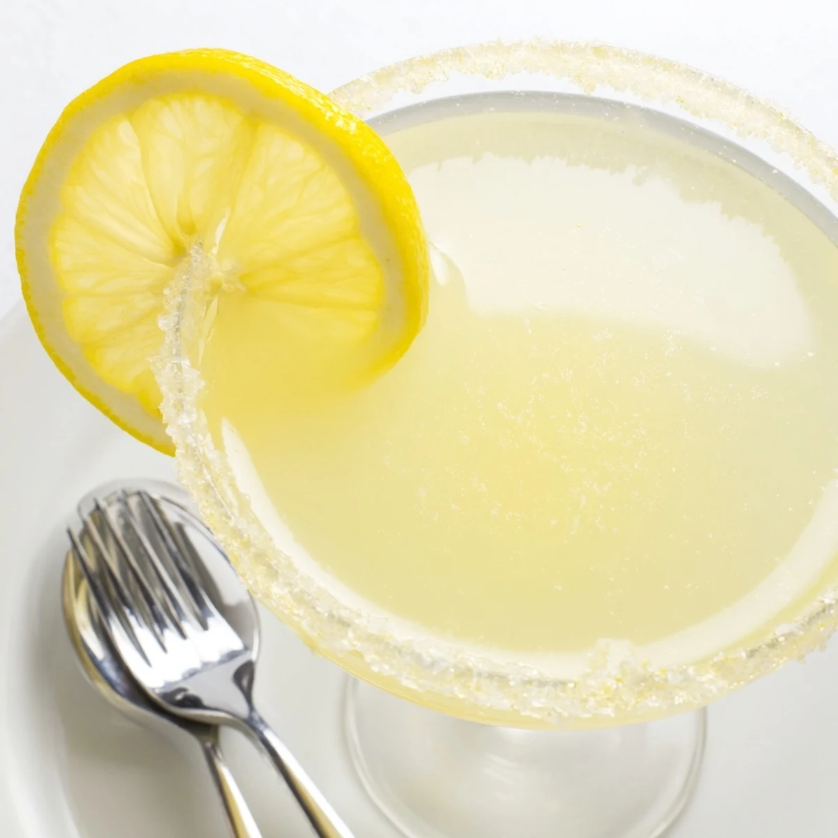 Elegant coupe glass filled with a Lemon Drop, ready for serving at a party.