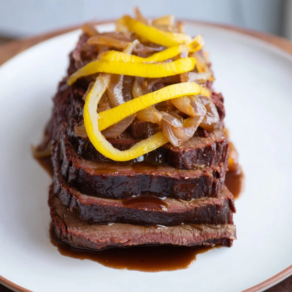 Mouthwatering slow cooked beef brisket with tender onions, served with rich, savory pan juices.