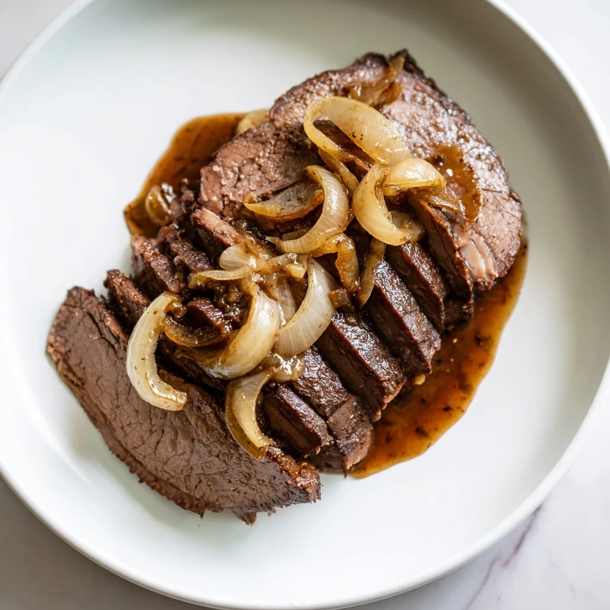Delicious slow cooked beef brisket, ready to serve with sides like mashed potatoes for dinner.