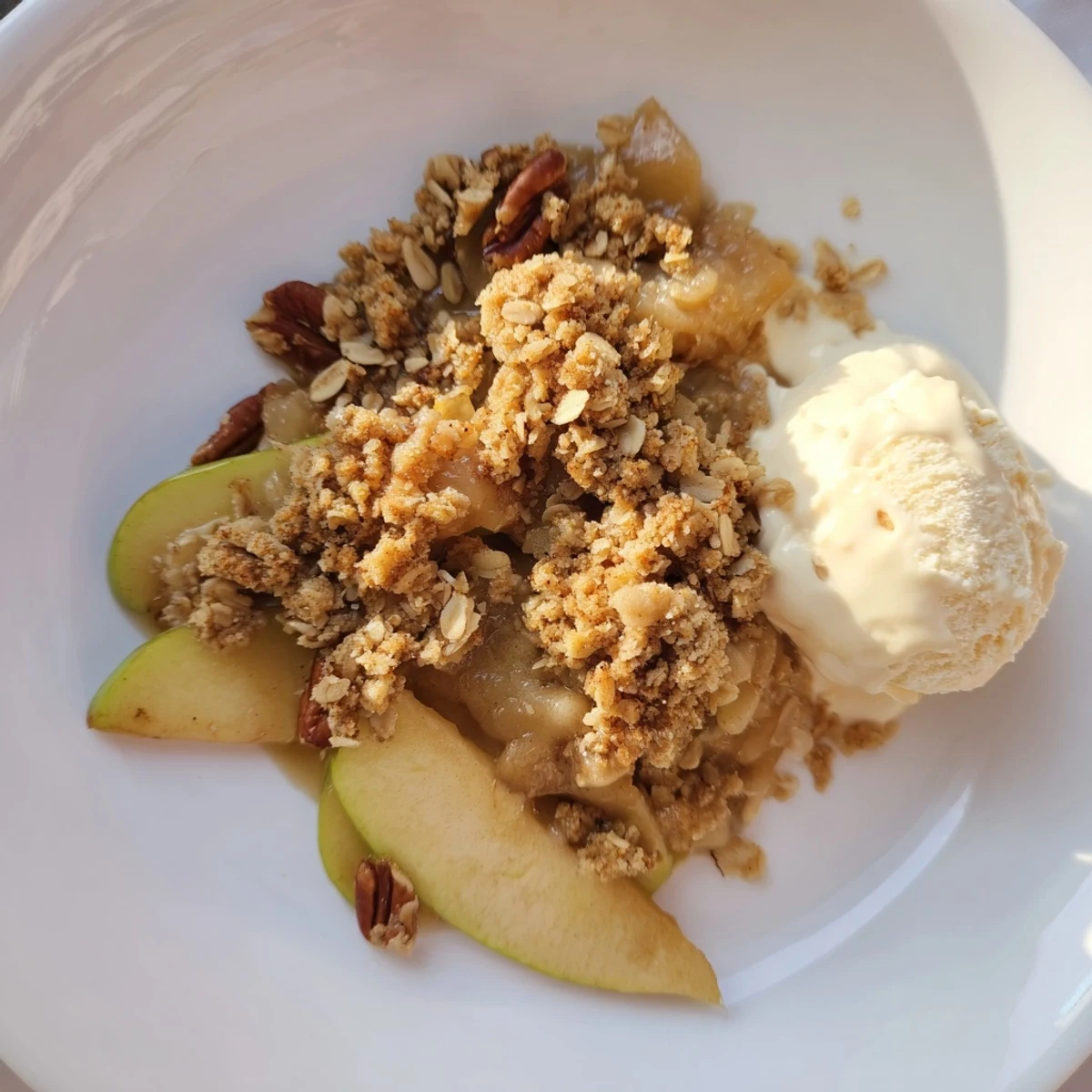 Golden brown Warm Apple Crisp featuring a bubbly apple filling under a crunchy oat topping.