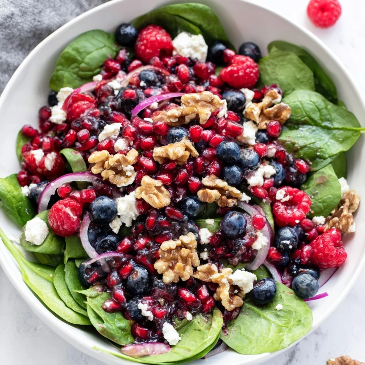 Close-up of a colorful, healthy Winter Berry and Spinach Salad, appealing with crunchy nuts and berries.