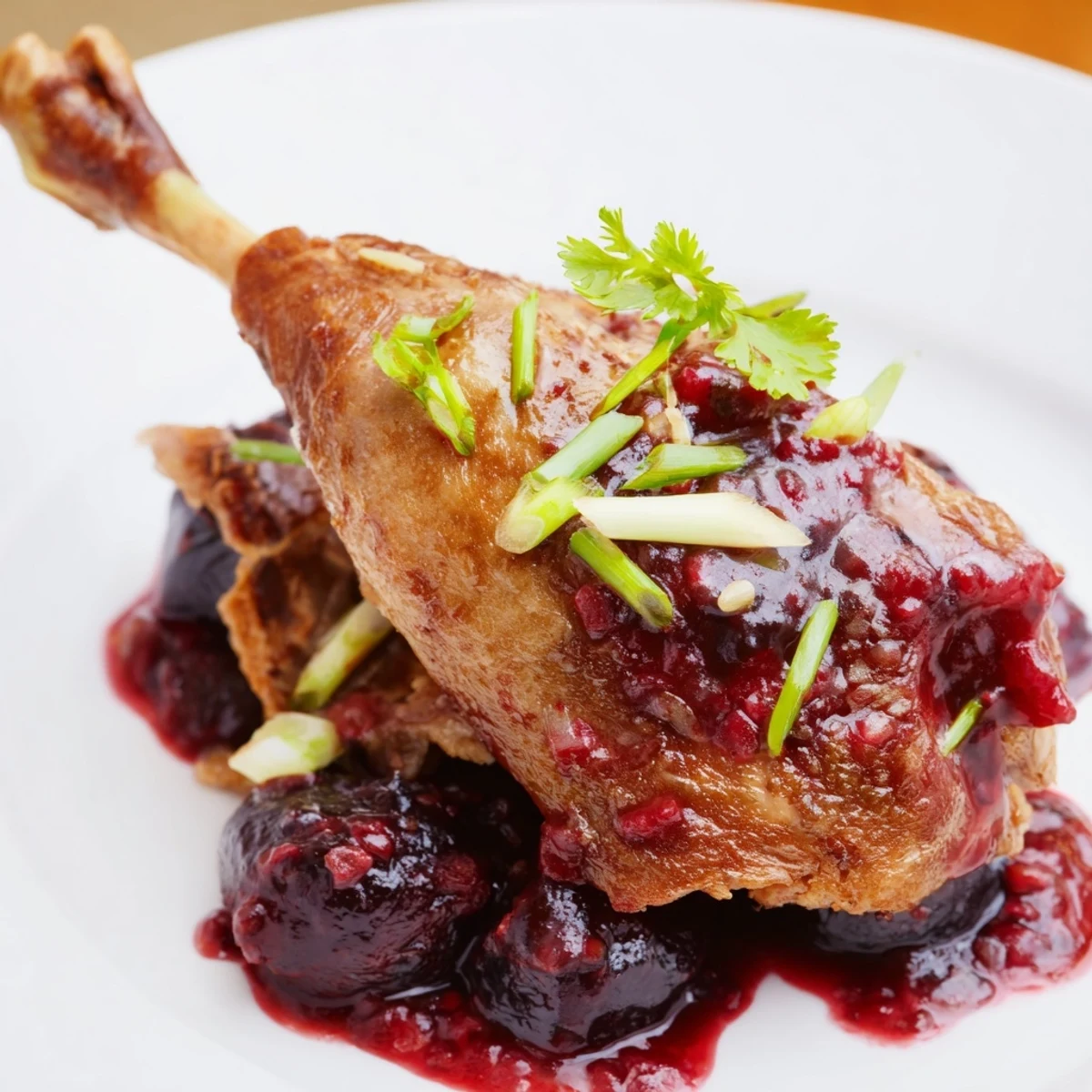 Tender Roasted Duck Legs, served with a vibrant plum sauce, perfect for a special meal.