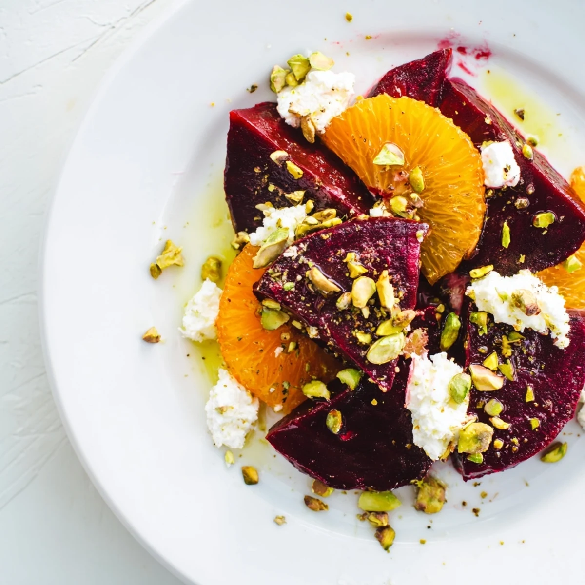 Vibrant photo of Roasted Beet and Blood Orange Salad, showcasing colorful components arranged beautifully on greens.