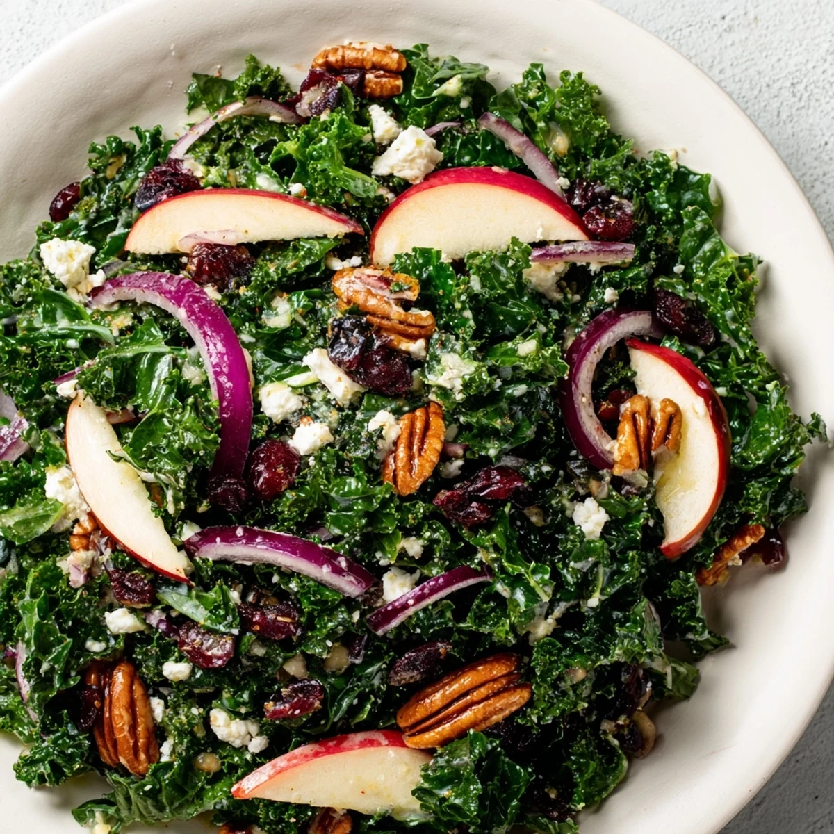 A vibrant Winter Kale Salad with Pecans and Cranberries features massaged kale, toasted pecans, and tart dried cranberries tossed in a zesty maple-Dijon vinaigrette.