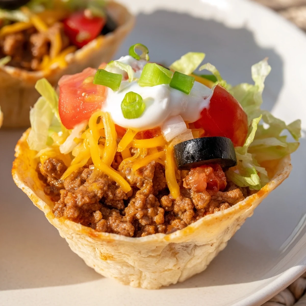 Sizzling ground beef with onions and garlic fills 12 crispy baked tortilla cups, topped with shredded lettuce and tomatoes. 