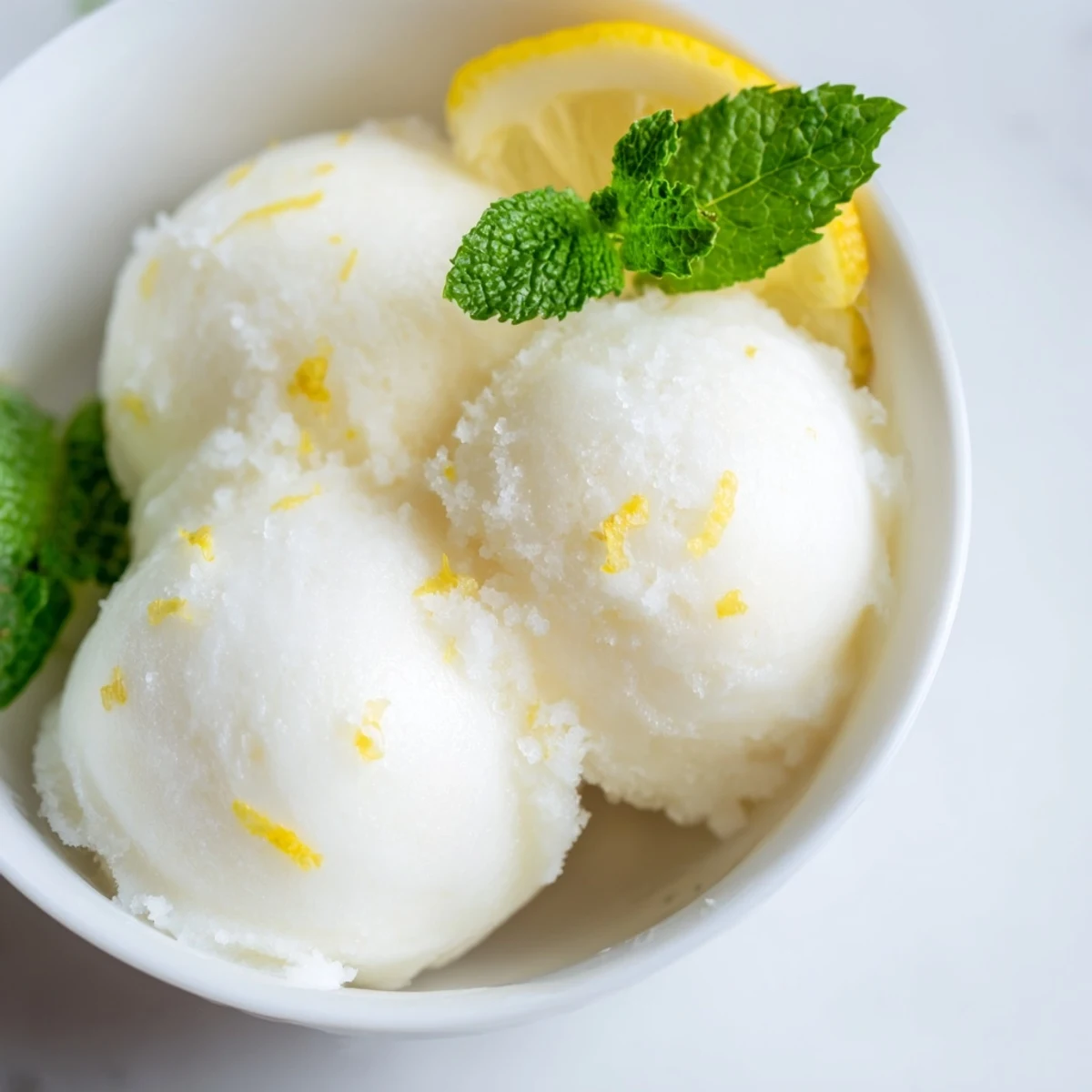 Served Lemonade Sorbet with Mint in a rustic bowl, ready to enjoy on a hot summer afternoon.