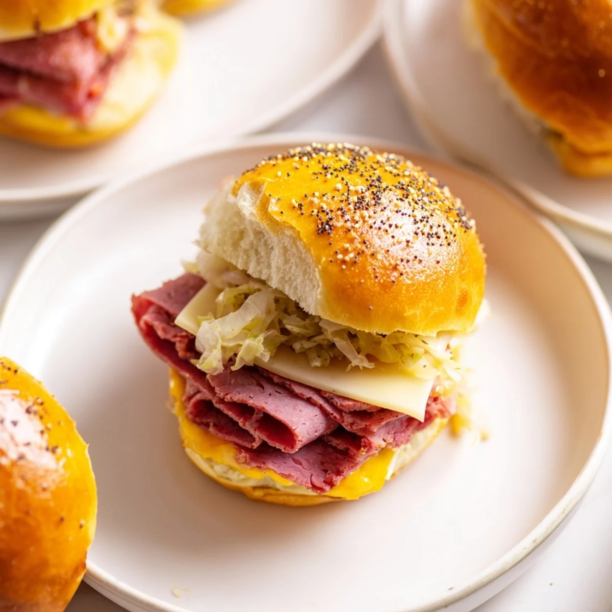Freshly baked Corned Beef Sliders with Mustard feature shredded cabbage and rich mustard spread.