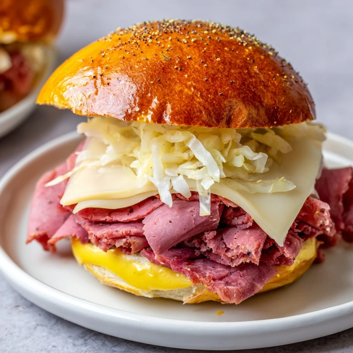 Buttery poppy seed topping on warm Corned Beef Sliders with Mustard, served with tangy sauerkraut.