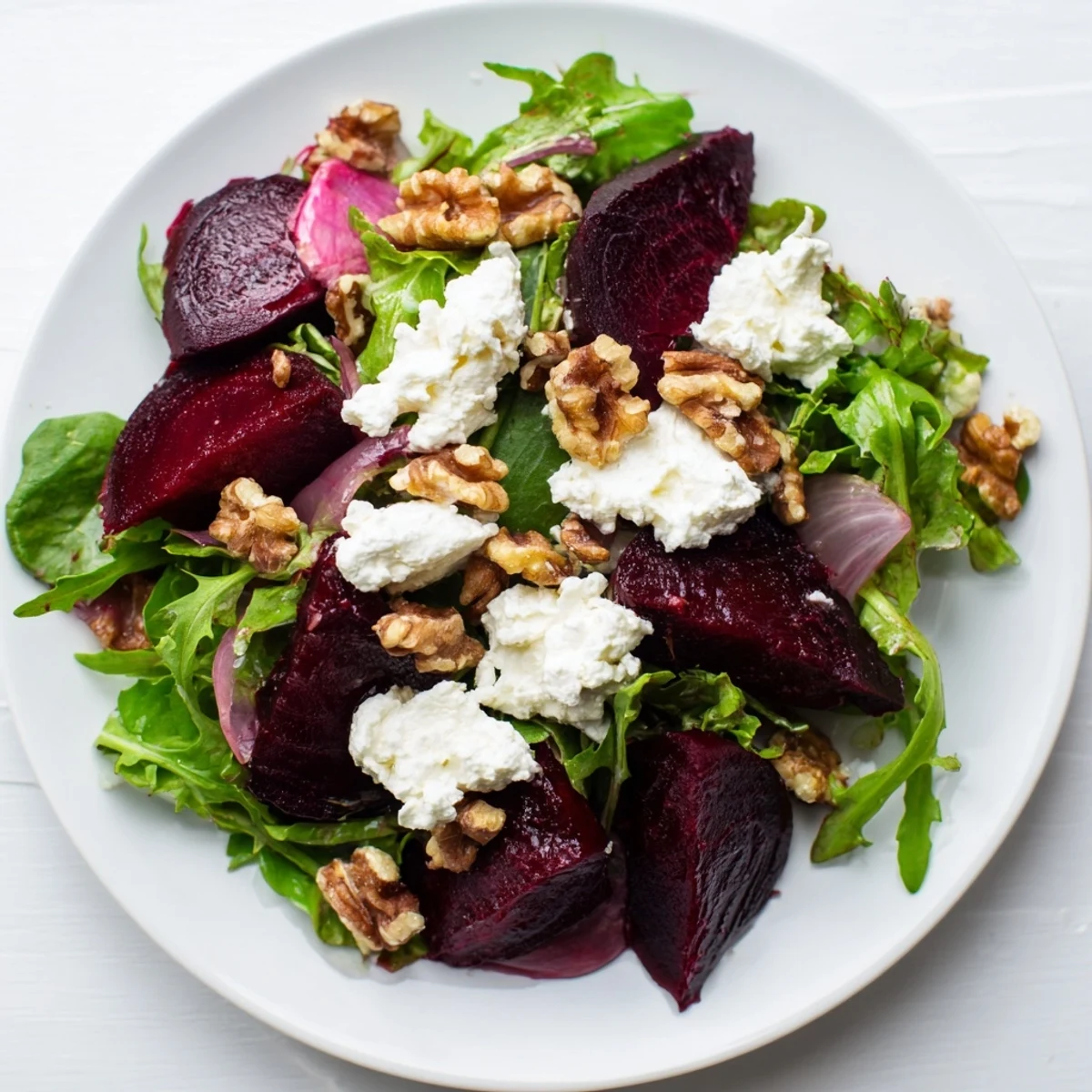 In the Roasted Beet Salad with Goat Cheese Crumbles, ruby beets and creamy cheese contrast with crisp arugula and balsamic glaze.