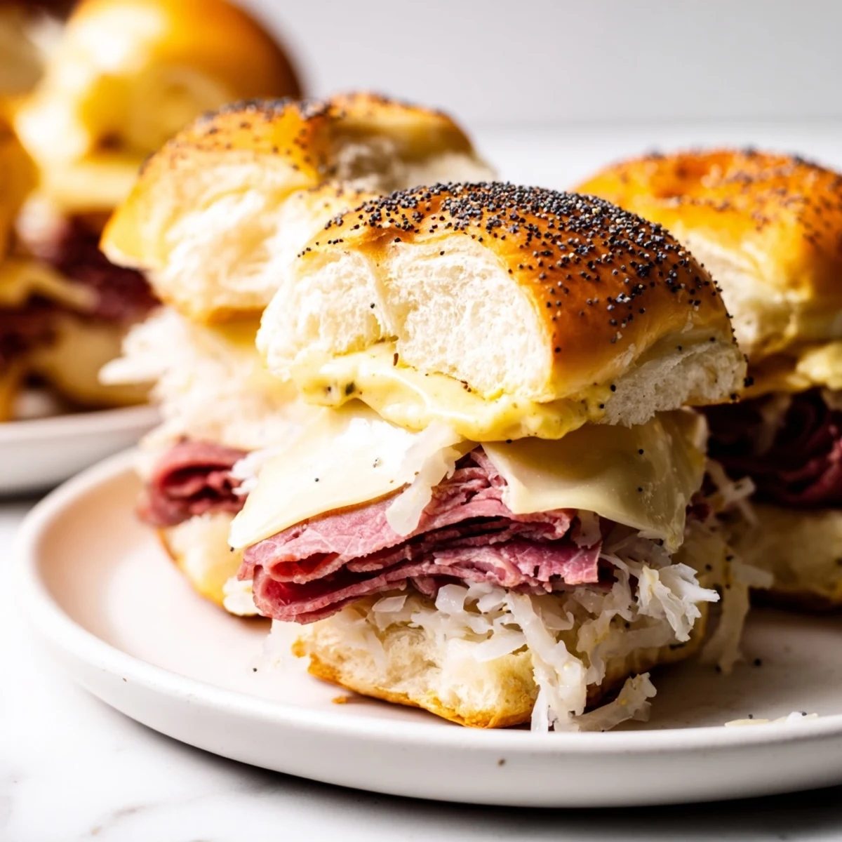 Golden Corned Beef Sliders with Stone Ground Mustard are baked until the Swiss cheese melts over savory beef on soft rolls.