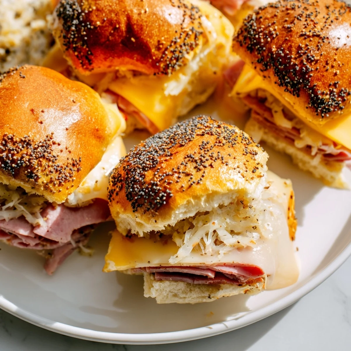 Freshly baked Corned Beef Sliders with Stone Ground Mustard reveal shredded cabbage and melted Swiss cheese tucked inside buttery brioche buns.