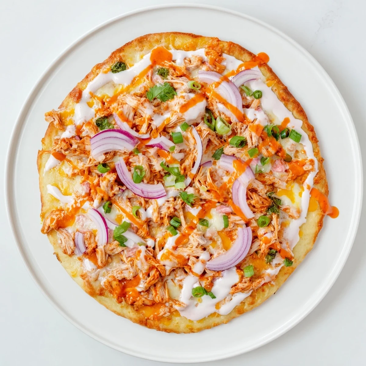 Freshly baked Bold Buffalo Chicken Pizza emerges from the oven, golden crust loaded with spicy shredded chicken and melted mozzarella.