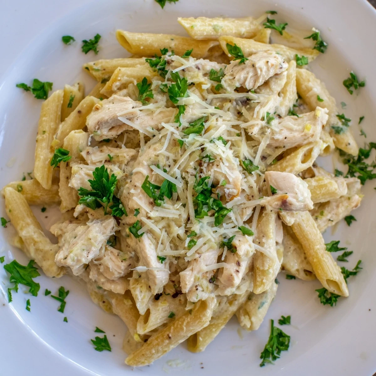 For this busy weeknight Crockpot Garlic Parmesan Chicken Pasta, shredded chicken breast simmers in a thick, garlicky sauce with penne noodles, heavy cream, and Italian seasoning.