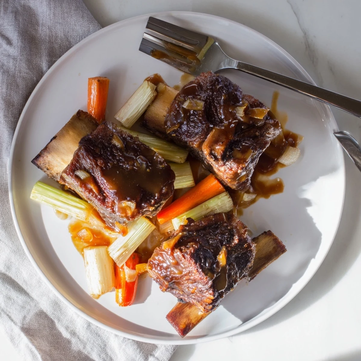Rich, fall-off-the-bone Maple Bourbon Glazed Short Ribs in a heavy Dutch oven, bubbling.