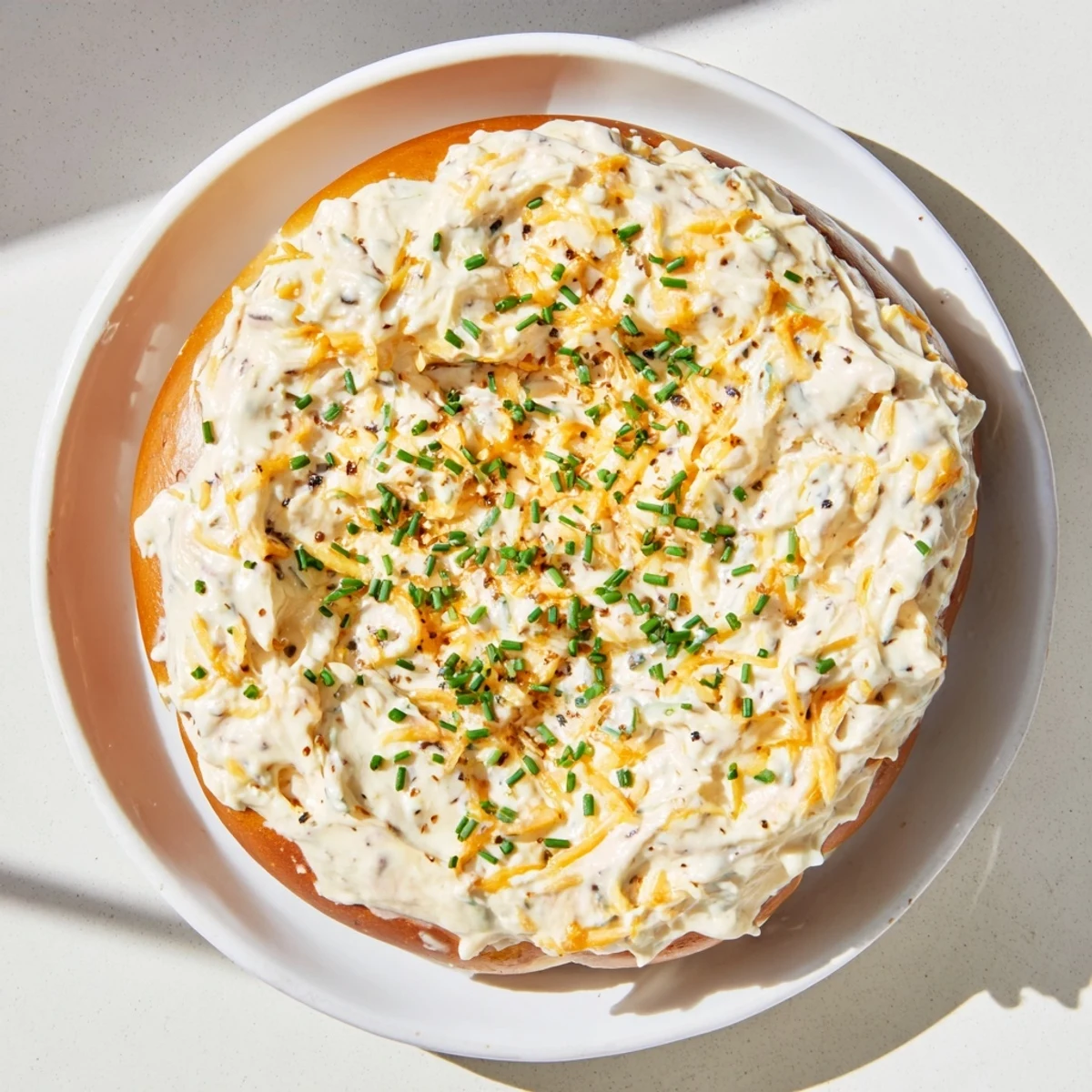 Rich cheddar savory pretzel dip with Dijon mustard served in a white bowl at parties