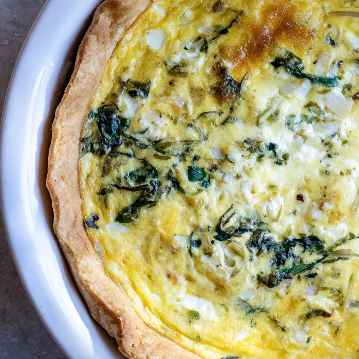 Savory vegetarian egg pie featuring silverbeet ricotta filling with golden parmesan topping