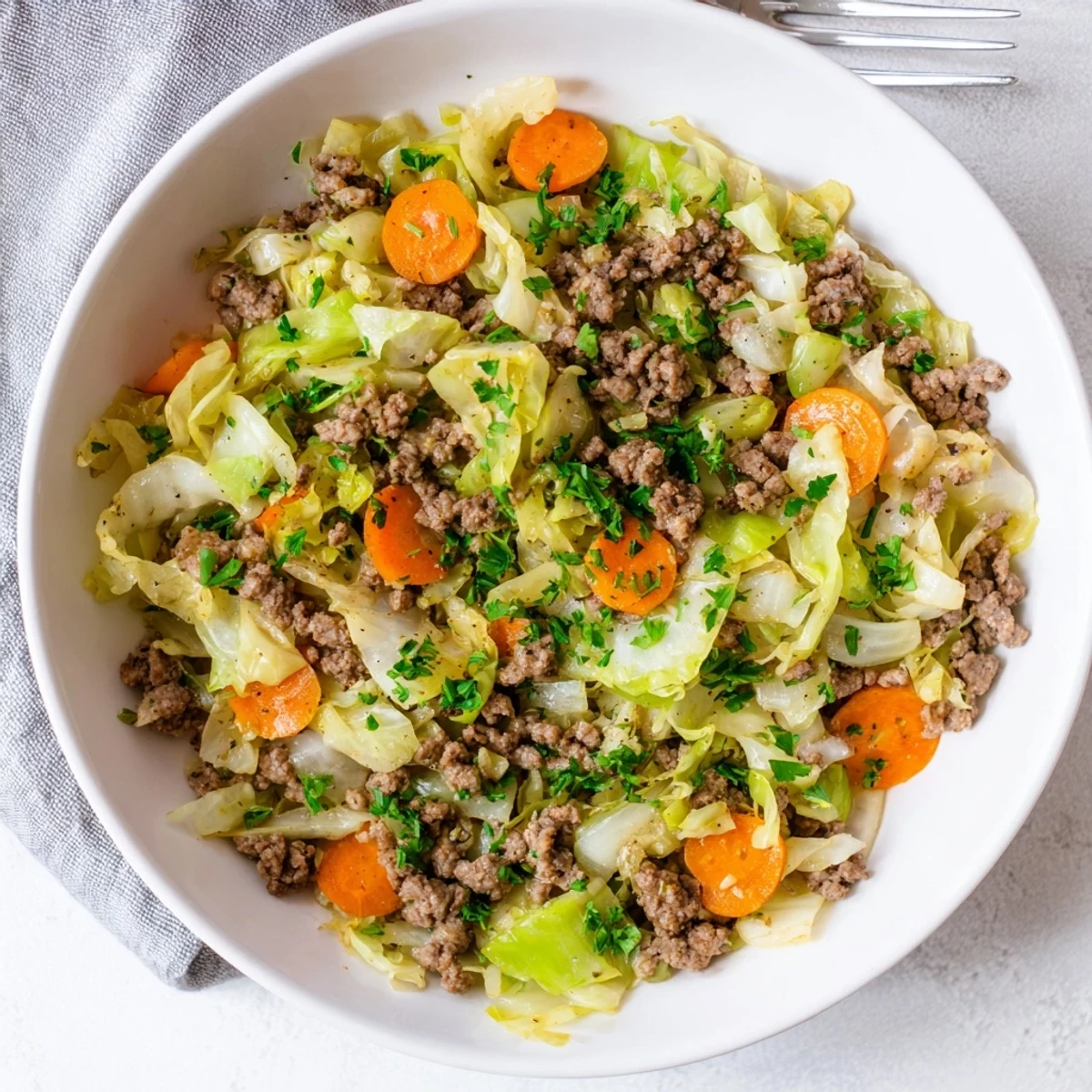 Comforting one-pan Irish ground beef and cabbage meal steaming hot with vibrant vegetables and savory seasonings