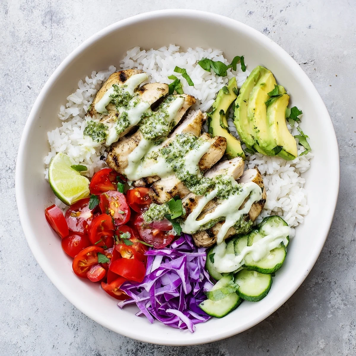 Vibrant chimichurri grilled chicken bowl featuring sliced chicken breast with colorful veggies and garlic drizzle