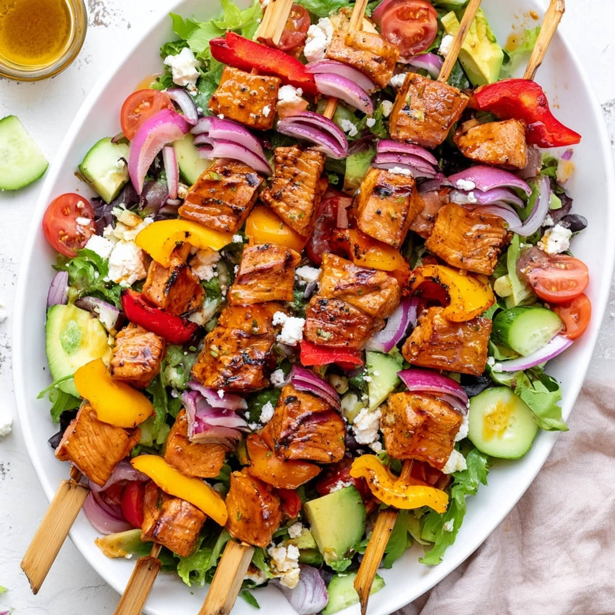 Summer BBQ chicken skewer salad with charred meat and colorful bell peppers on greens