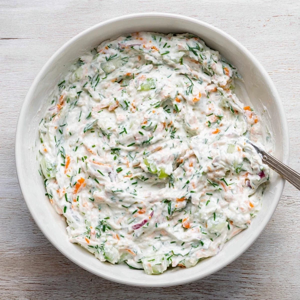 Smooth creamy Easter spread with chives and radishes arranged beside crisp vegetables for holiday entertaining