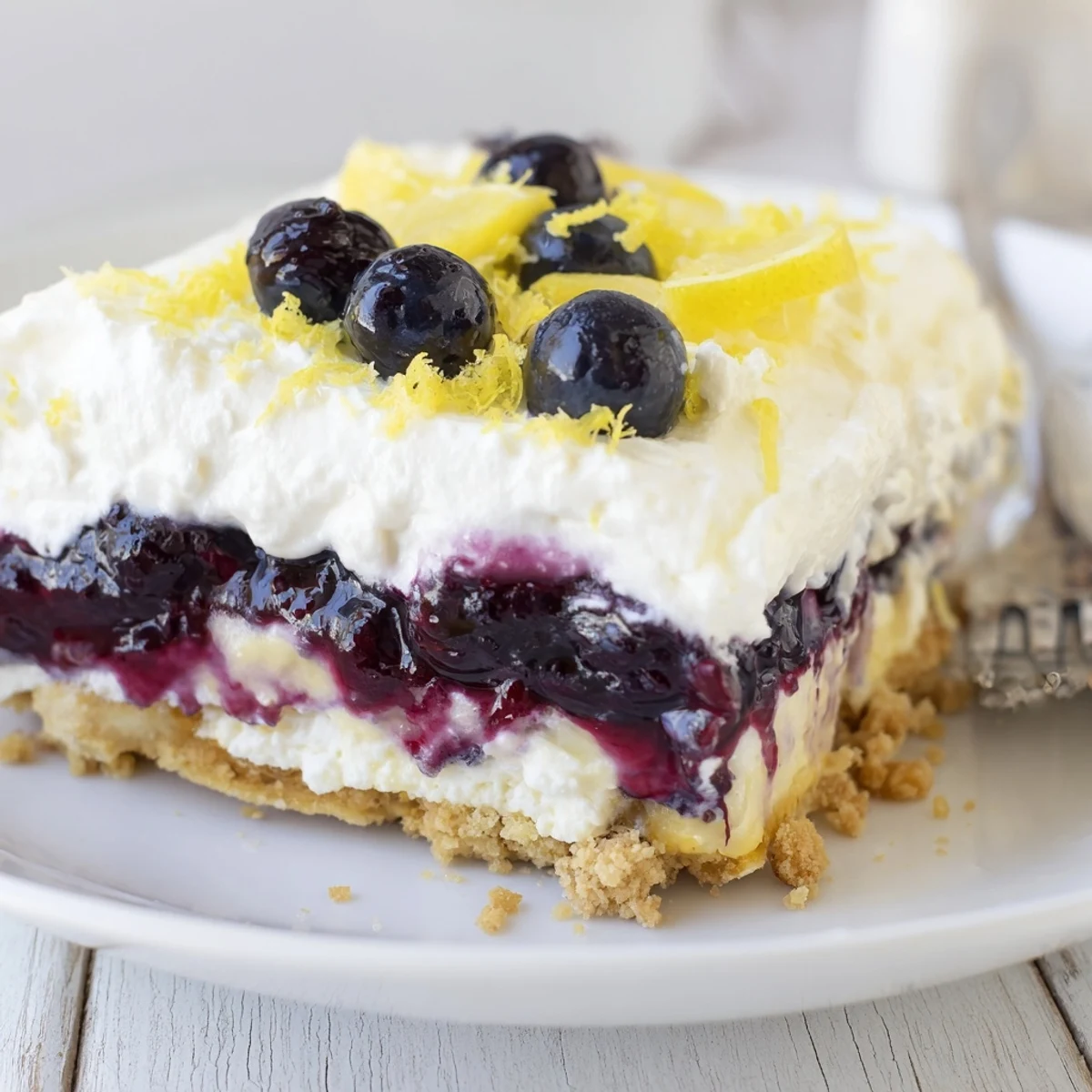 Chilled Lemon Blueberry Lasagna Recipe served with whipped cream, bright lemon zest