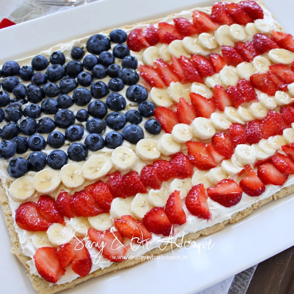 A festive American Flag Fruit Pizza arranged with blueberries, banana stripes, ready to serve