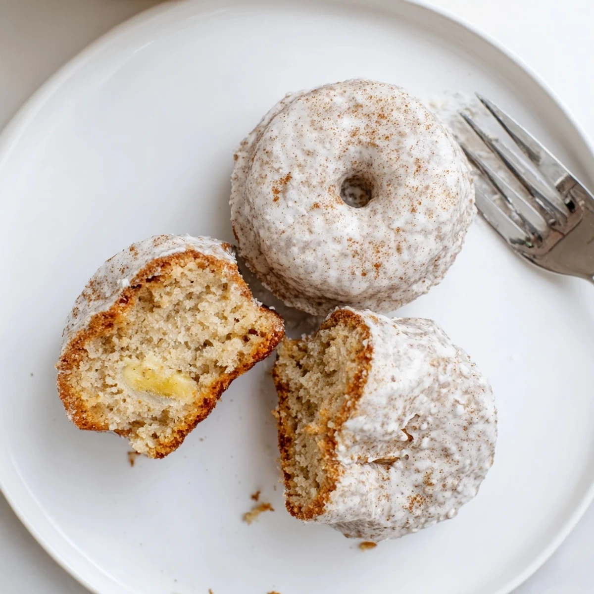 Warm Banana Donuts glazed and stacked on a wire rack, morning aroma.