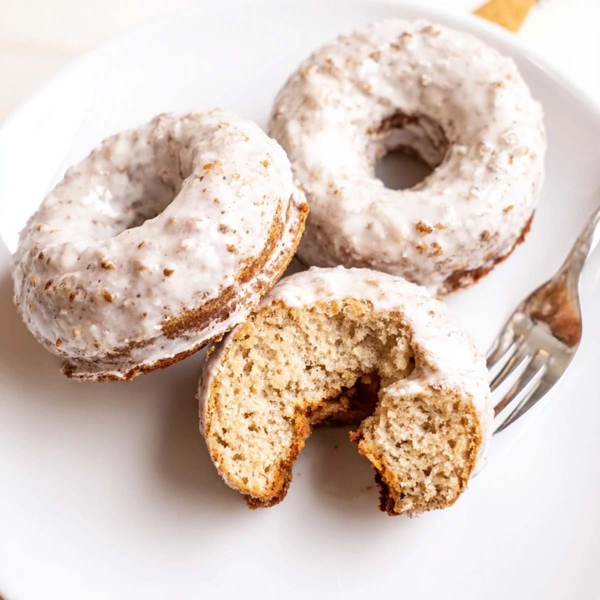 Plated with coffee, soft Banana Donuts dusted with cinnamon and powdered sugar.