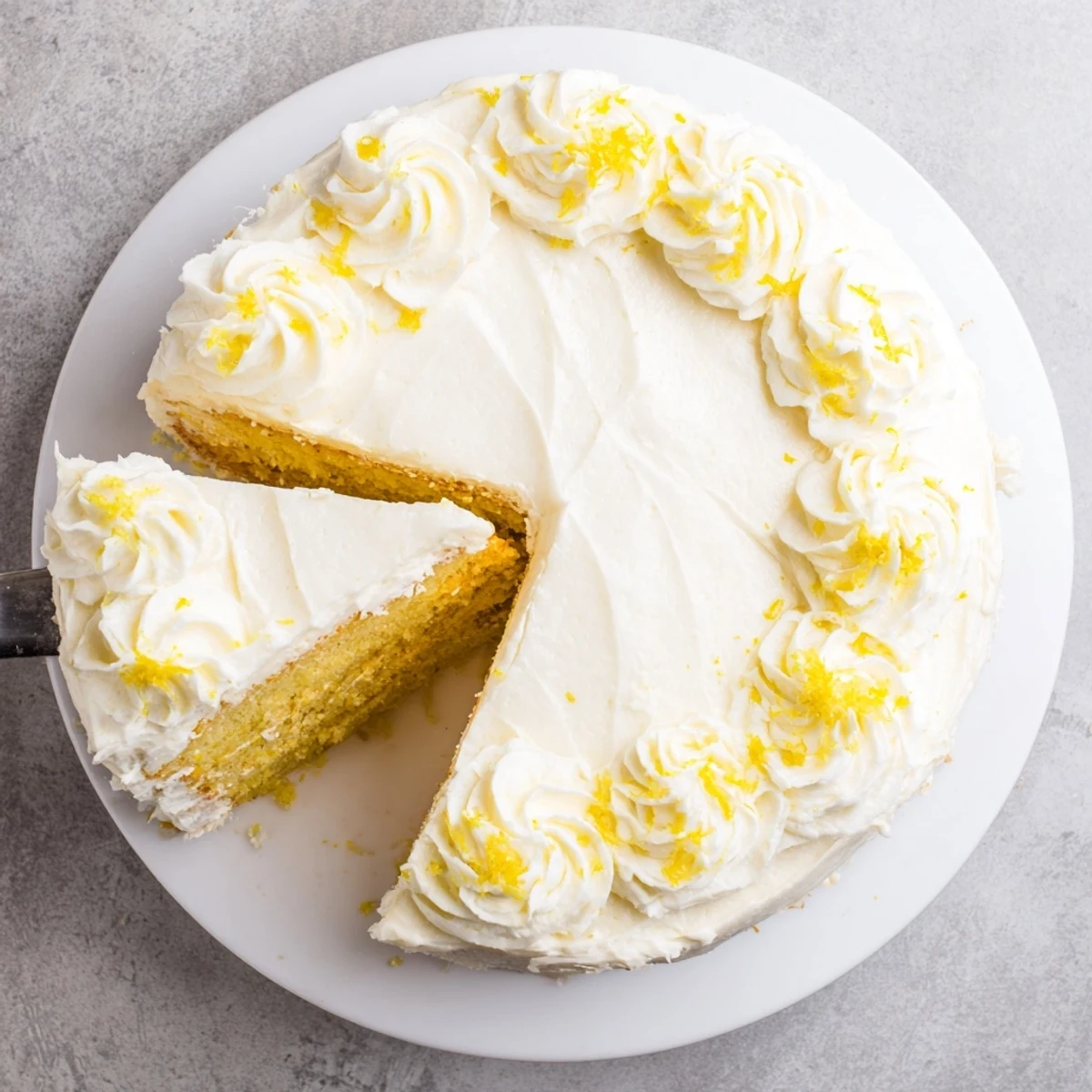 Festive Lemon Birthday Cake topped with decorative lemon slices and smooth swirled white frosting
