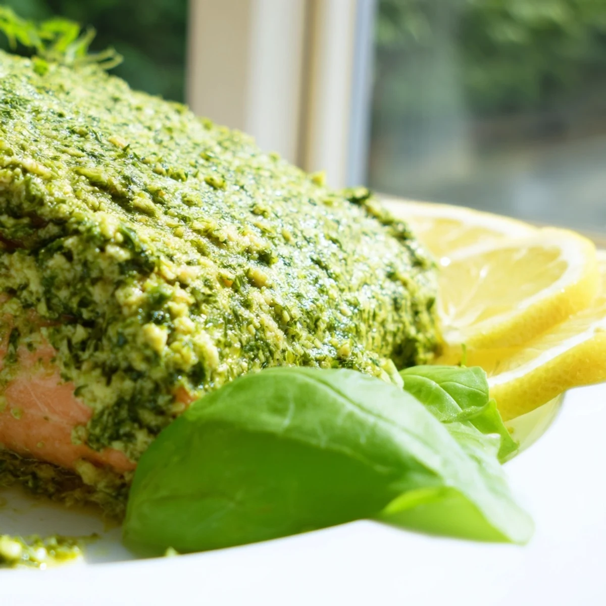 Golden brown pesto butter salmon fillet baked to flaky perfection with melted herby butter glaze