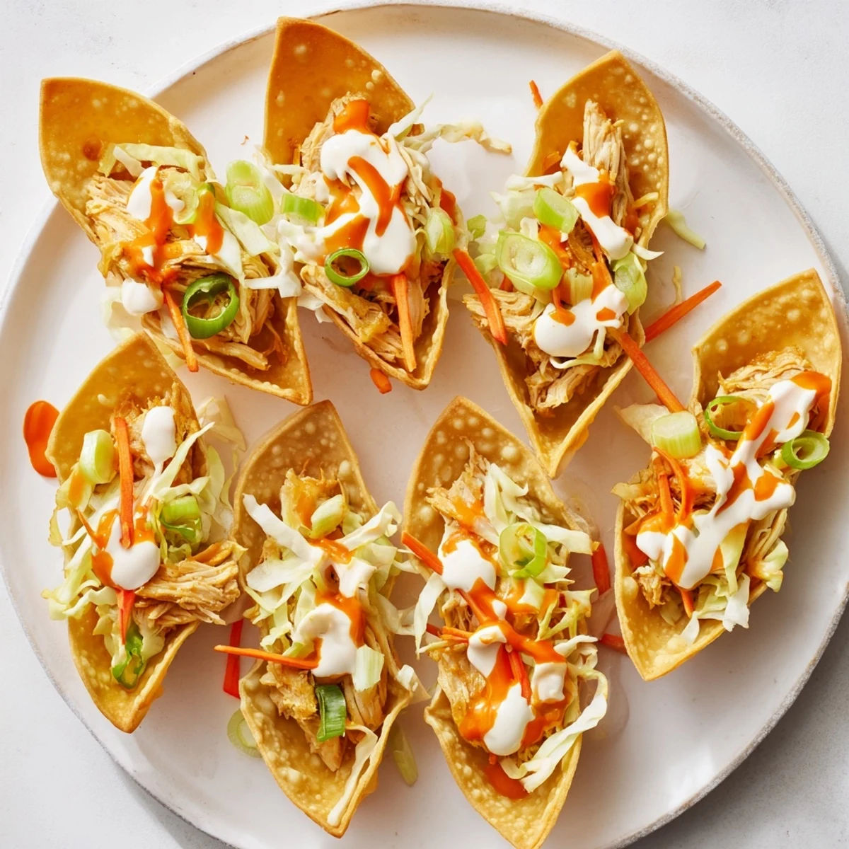 Baked wonton shell tacos filled with savory hoisin chicken and fresh crunchy vegetable slaw topping