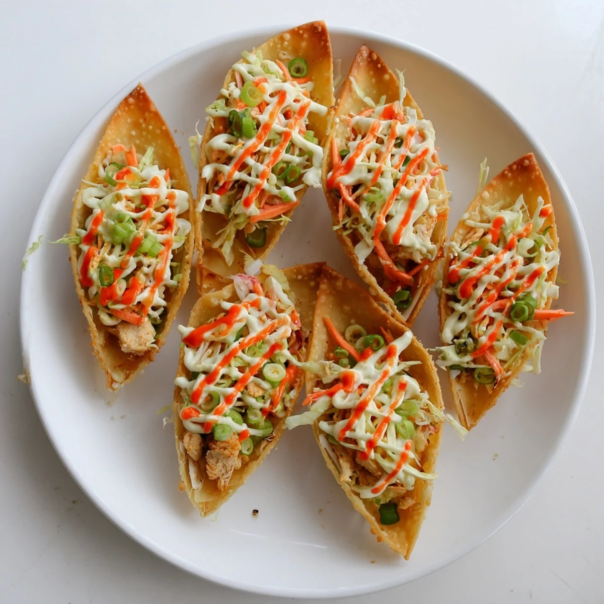 Fusion appetizer featuring juicy marinated chicken nestled in crispy wonton wrappers with zesty lime dressing
