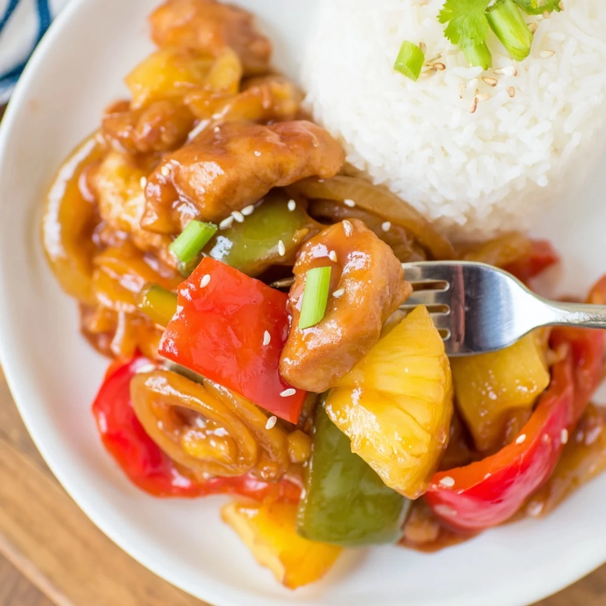 Sweet Hawaiian Crockpot Chicken simmering with pineapple, bell peppers, and glossy sauce