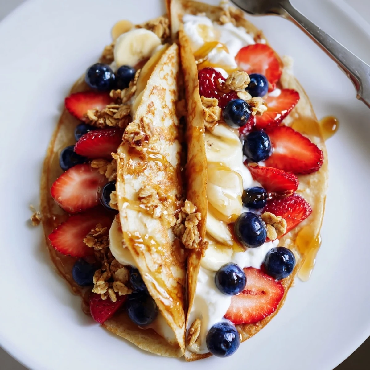 Fluffy pancake tacos folded taco-style and stuffed with scrambled eggs and crumbled bacon