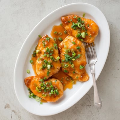 Classic Apricot Chicken served hot with fluffy rice and steamed green beans on a rustic dinner plate.