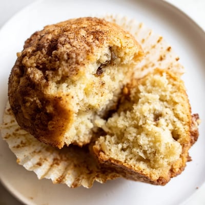 Soft banana muffins studded with chocolate chips arranged on a rustic kitchen towel