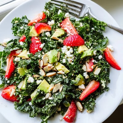 Vibrant summer kale salad drizzled with lemon-honey dressing in a rustic bowl.